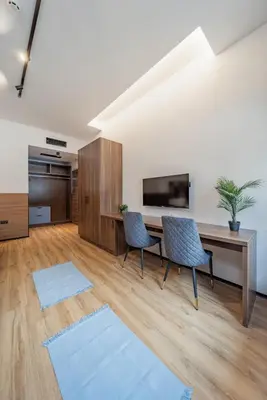 a living room with a desk and two chairs at Hotel Garni VIZURA Sport in Belgrade
