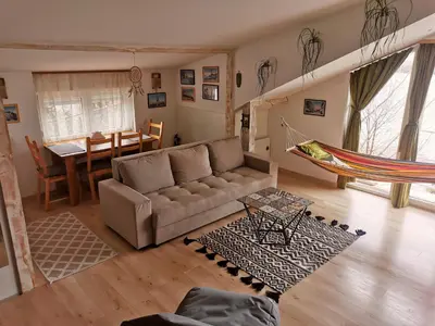 a living room with a couch and a hammock in it at Gardos riverview in Belgrade