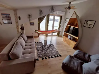 a living room with a couch and a hammock at Gardos riverview in Belgrade