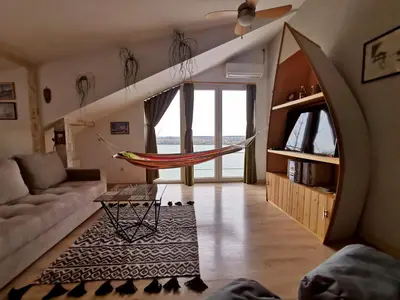 a living room with a hammock in the middle at Gardos riverview in Belgrade