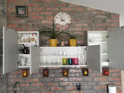 a brick wall with white shelves and a clock at Gardos riverview in Belgrade