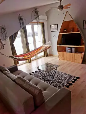 a living room with a couch and a hammock at Gardos riverview in Belgrade