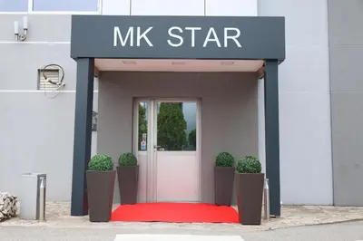 a mink star building with a red carpet and a door at MK Star Boutique Hotel in Belgrade
