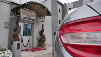 a red car parked in front of a building at MK Star Boutique Hotel in Belgrade