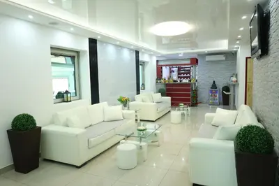 a living room with white couches and a table at MK Star Boutique Hotel in Belgrade