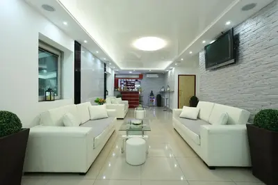 a living room with white couches and a tv at MK Star Boutique Hotel in Belgrade