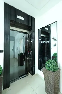 a glass entrance to a building with two potted plants at MK Star Boutique Hotel in Belgrade