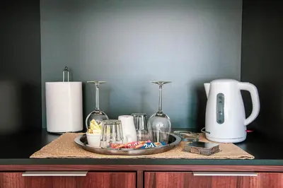 a counter with a plate of food and a coffee maker at Apartment Nikola Tesla in Belgrade
