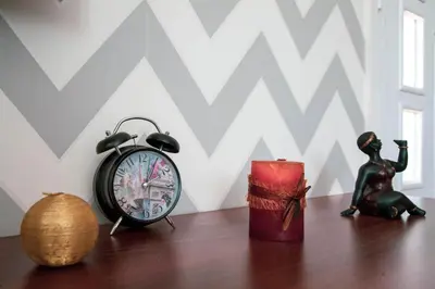 an alarm clock and a figurine on a table at Apartment Nikola Tesla in Belgrade