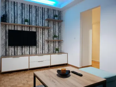 a living room with a tv and a table at Apartment Nikola Tesla in Belgrade