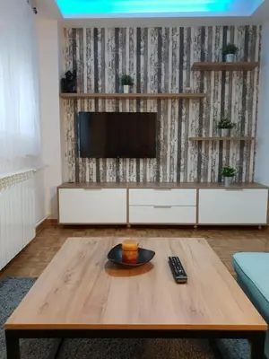 a living room with a tv and a coffee table at Apartment Nikola Tesla in Belgrade