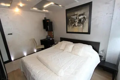 a bedroom with a white bed in a room at Business & Travel Apartments in Belgrade