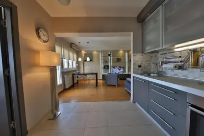 a kitchen with a counter and a dining room at Business & Travel Apartments in Belgrade