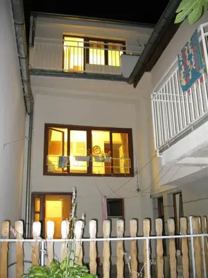 a house with a balcony and a fence at Hostel Oasis in Belgrade