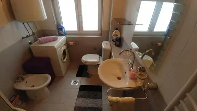 a small bathroom with a sink and a toilet at Talas apartmani in Belgrade