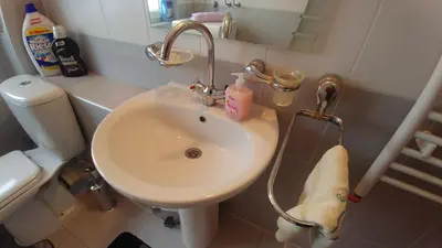 a bathroom with a sink and a toilet at Talas apartmani in Belgrade