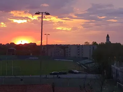 a sunset over a soccer field in a city at Talas apartmani in Belgrade