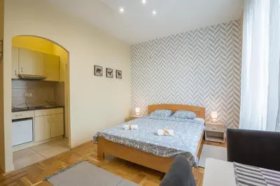 a small bedroom with a bed and a kitchen at Belgrade Center Apartment Skadarlija in Belgrade