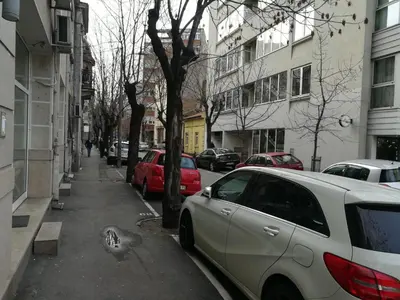 a street with cars parked on the sidewalk at Belgrade Center Apartment Skadarlija in Belgrade