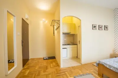 a room with a kitchen and a hallway at Belgrade Center Apartment Skadarlija in Belgrade