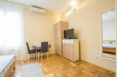 a bedroom with a desk and a table with two chairs at Belgrade Center Apartment Skadarlija in Belgrade