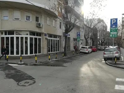 a street with cars parked in front of a building at Belgrade Center Apartment Skadarlija II in Belgrade