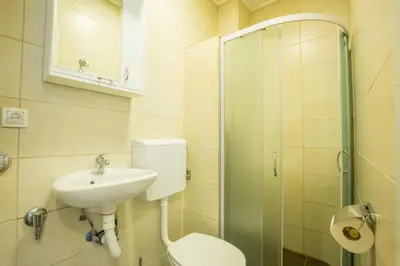 a bathroom with a toilet and a sink and a shower at Belgrade Center Apartment Skadarlija II in Belgrade