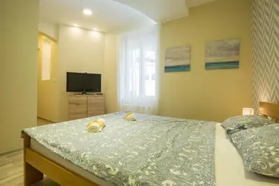 a bedroom with a bed and a television in it at Belgrade Center Apartment Skadarlija II in Belgrade