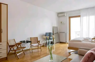 a living room with a bed and a table and chairs at Danube Pearl in Belgrade