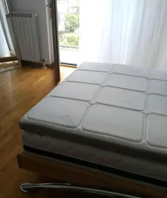 a white bed in a room with a window at Danube Pearl in Belgrade