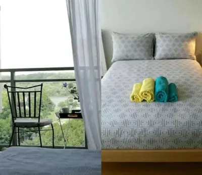 a bedroom with a bed with a chair and a window at Danube Pearl in Belgrade