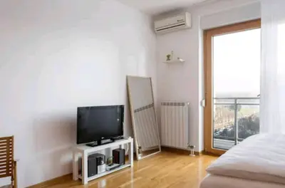 a living room with a television and a bed at Danube Pearl in Belgrade