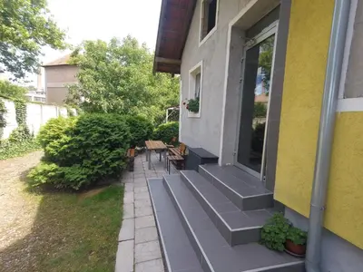a porch of a house with benches on it at Hostel Respect in Pančevo