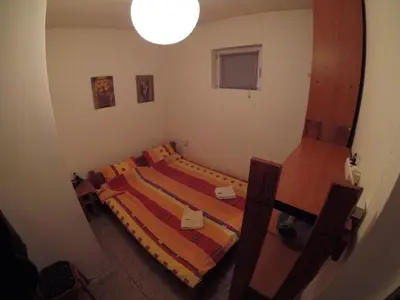 a small room with two beds and a lamp at Hostel Respect in Pančevo