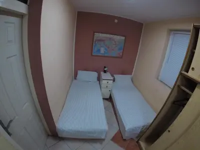 a small room with two beds in it at Hostel Respect in Pančevo