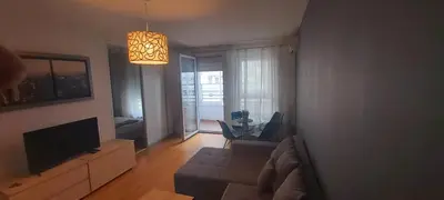 a living room with a couch and a television at Apartman Metropol Belville in Belgrade