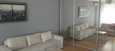 a living room with a couch and a chair at Apartman Metropol Belville in Belgrade