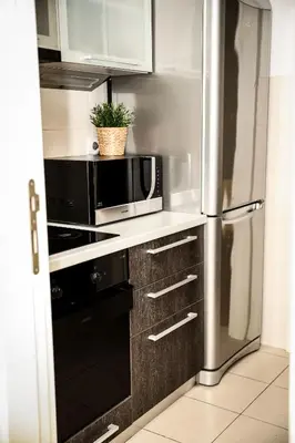 a kitchen with a microwave and a refrigerator at Apartman Metropol Belville in Belgrade