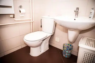 a bathroom with a white toilet and a sink at Apartman Metropol Belville in Belgrade