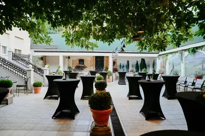 a courtyard with tables and chairs in a building at Hotel Jardin in Belgrade