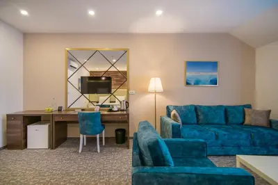 a living room with a blue couch and a desk at Luxury Rooms Skadarlija in Belgrade