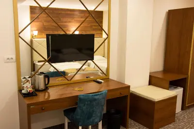 a desk with a television and a mirror in a room at Luxury Rooms Skadarlija in Belgrade