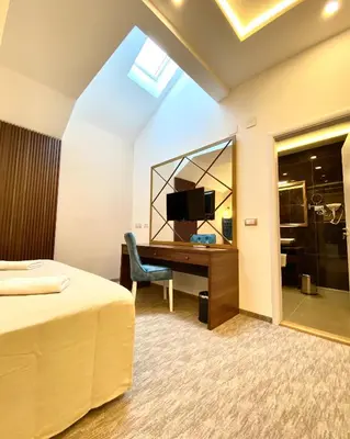 a hotel room with a desk and a tv at Luxury Rooms Skadarlija in Belgrade