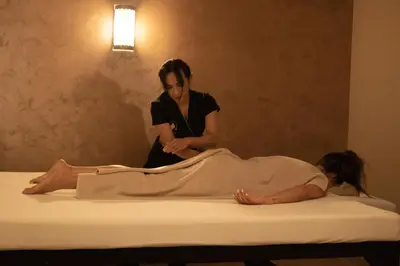 a woman getting a massage on a bed at Luxury Rooms Skadarlija in Belgrade