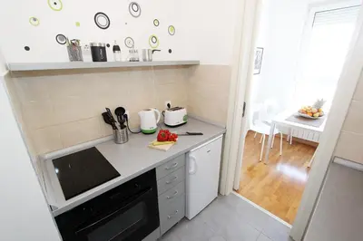 a small kitchen with a counter and a table at New Belgrade Apartments, parking 5 eur per day in Belgrade
