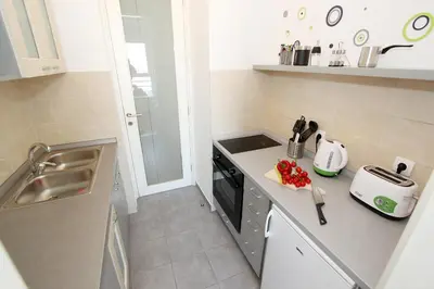 a small kitchen with a sink and a stove at New Belgrade Apartments, parking 5 eur per day in Belgrade