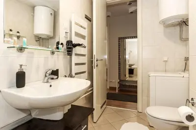 a white bathroom with a sink and a toilet at New Belgrade Apartments, parking 5 eur per day in Belgrade