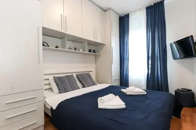 a bedroom with a bed with two towels on it at New Belgrade Apartments, parking 5 eur per day in Belgrade