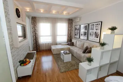 a living room with a couch and a table at New Belgrade Apartments, parking 5 eur per day in Belgrade