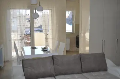 a living room with a couch and a table at Apartments Soleado in Pančevo